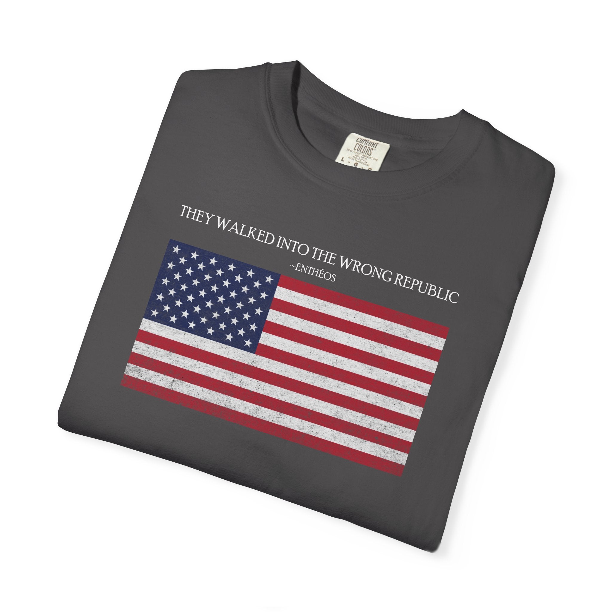 Folded Graphite Comfort Colors t-shirt with distressed American flag graphic and 'They Walked Into the Wrong Republic' quote from Entheos