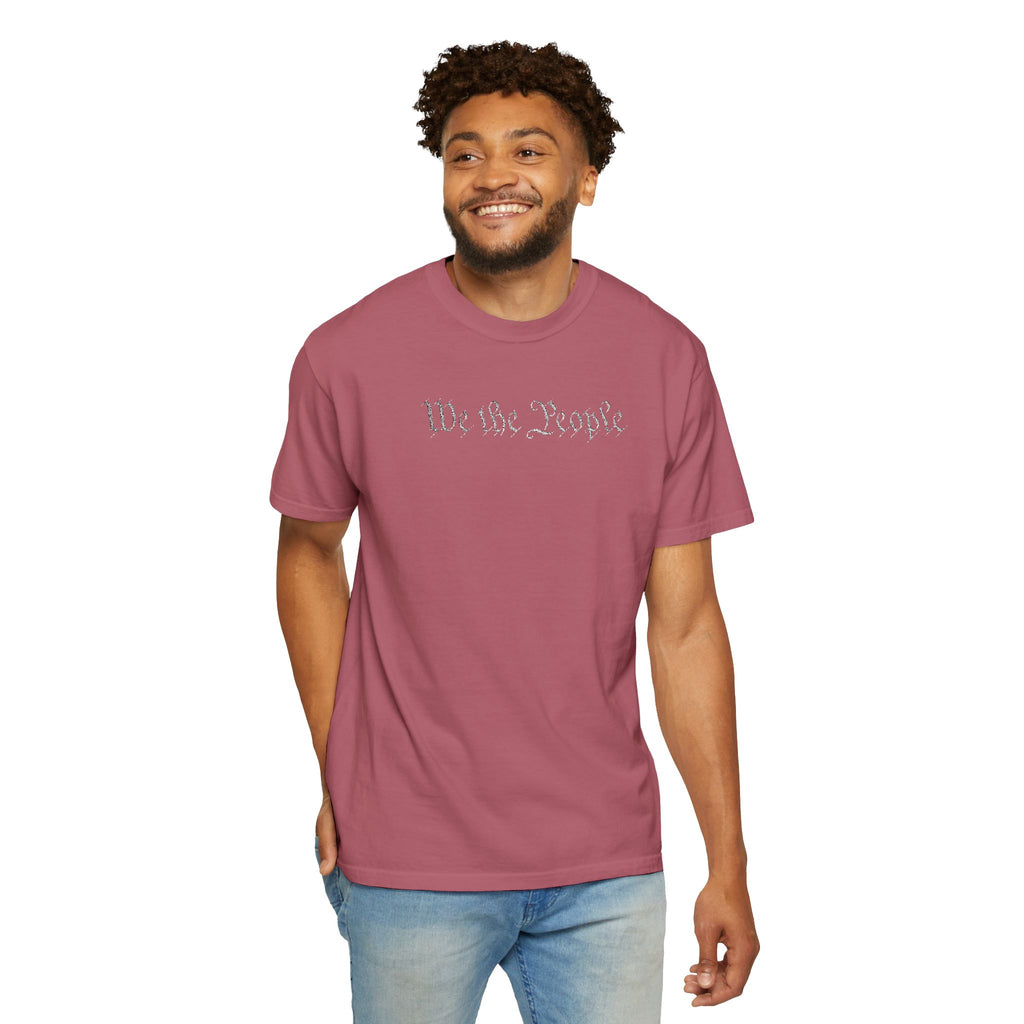Smiling man wearing 'We the People' embroidered t-shirt in crimson