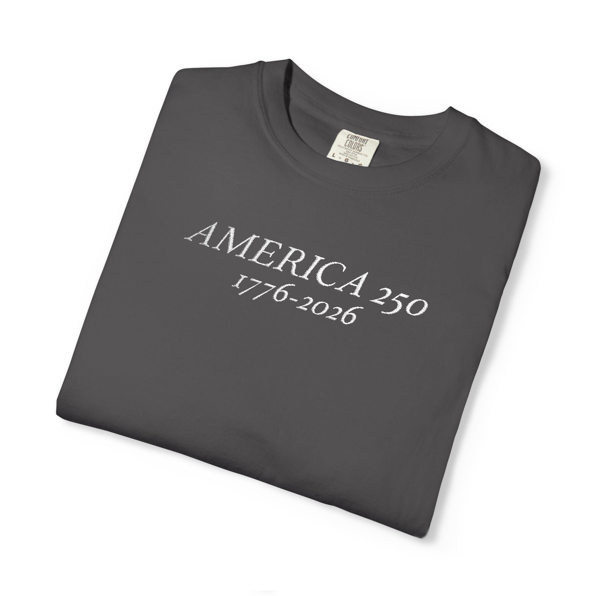 Folded Graphite Comfort Colors t-shirt with 'AMERICA 250 1776-2026' embroidered in white thread