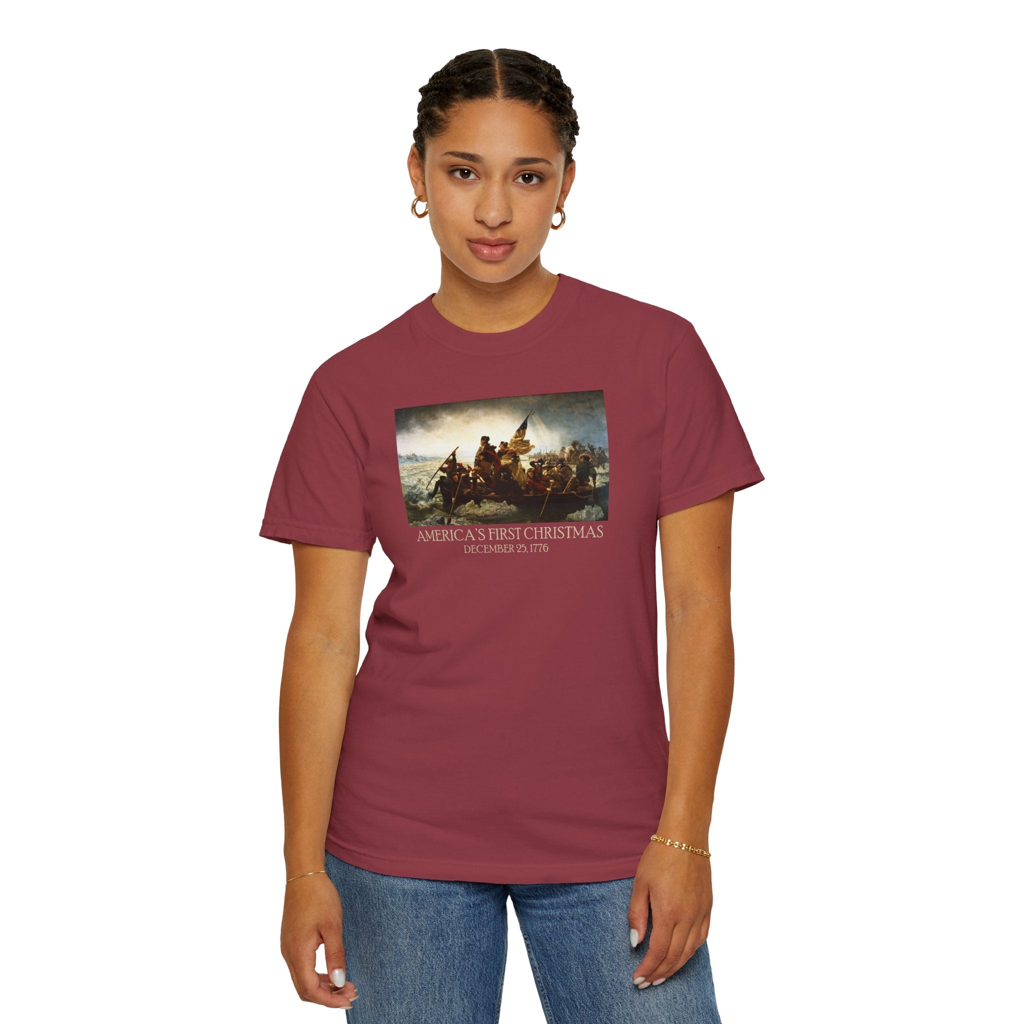 Woman wearing a Chili Comfort Colors t-shirt with print of Emanuel Leutze’s 'Washington Crossing the Delaware' with 'America's First Christmas December 25, 1776' printed below 