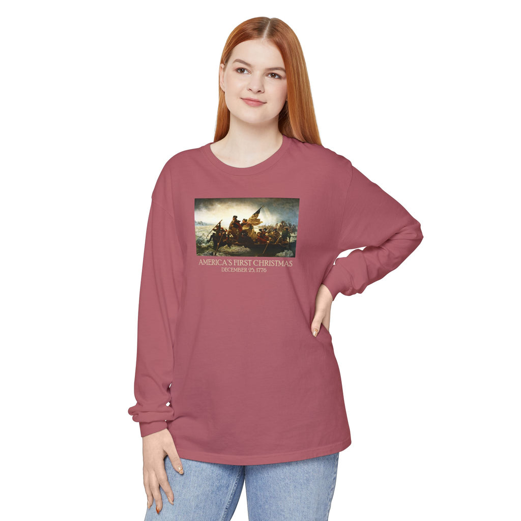 Woman wearing a long-sleeve Crimson Comfort Colors t-shirt with Leutze's 'Washington Crossing the Delaware' with 'America's First Christmas December 25, 1776 printed underneath