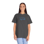 Smiling woman wearing an oversized Graphite Comfort Colors t-shirt with 'He restores my soul' embroidered in cornflower blue thread