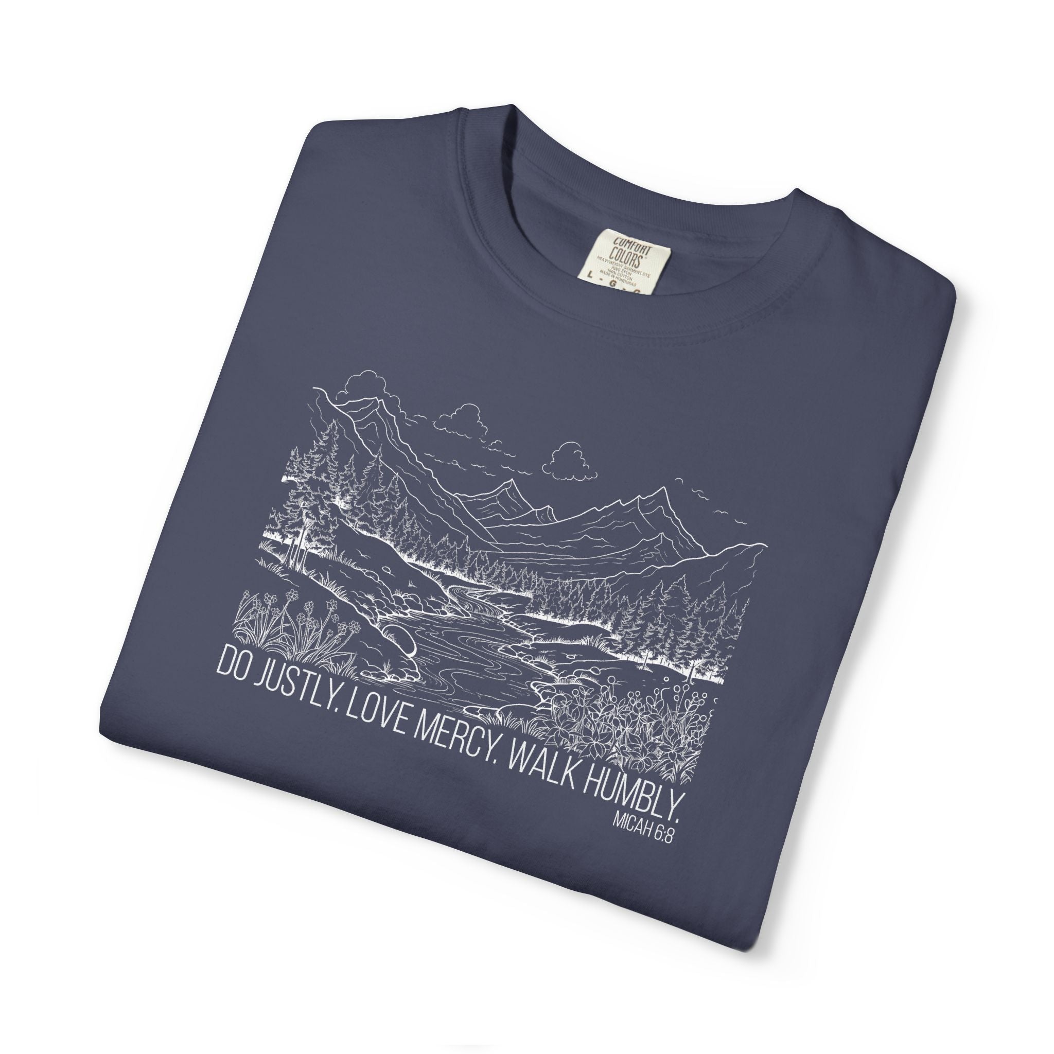 Folded Denim Comfort Colors t-shirt with mountain river design and Bible verse from Micah 6:8