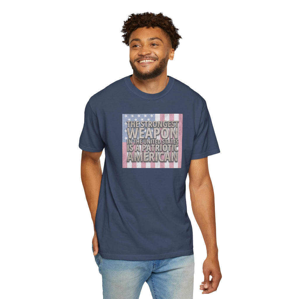 Smiling man wearing 'The Strongest Weapon in the United States is a Patriotic American' t-shirt in midnight