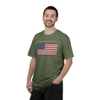 Smiling man wearing a Sage Comfort Colors t-shirt with distressed American flag graphic and 'They Walked Into the Wrong Republic' quote from Entheos