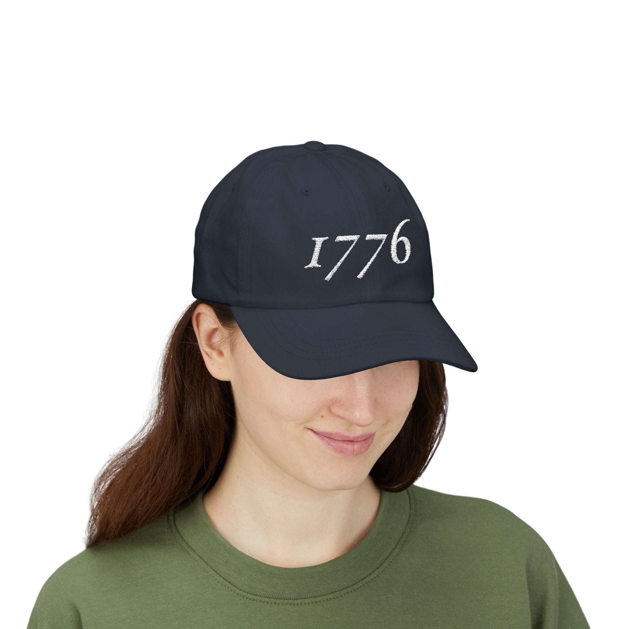 Front view of woman wearing a Navy dad cap embroidered with '1776'