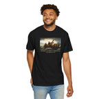 Man wearing a black Comfort Colors t-shirt with print of Emanuel Leutze’s 'Washington Crossing the Delaware' with 'America's First Christmas December 25, 1776' printed below 
