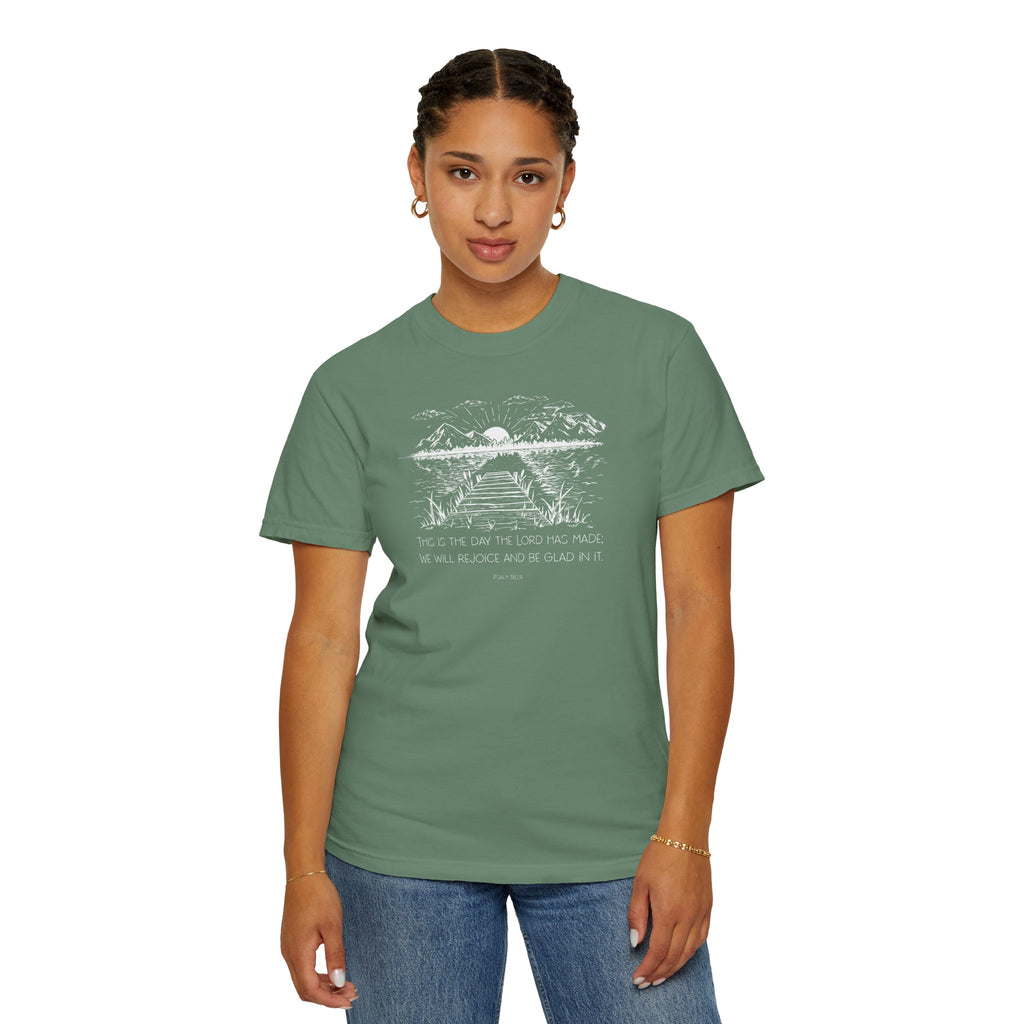 Woman wearing Light Green Comfort Colors t-shirt with nature graphic and 'This is the day the Lord has made; We will rejoice and be glad in it' below