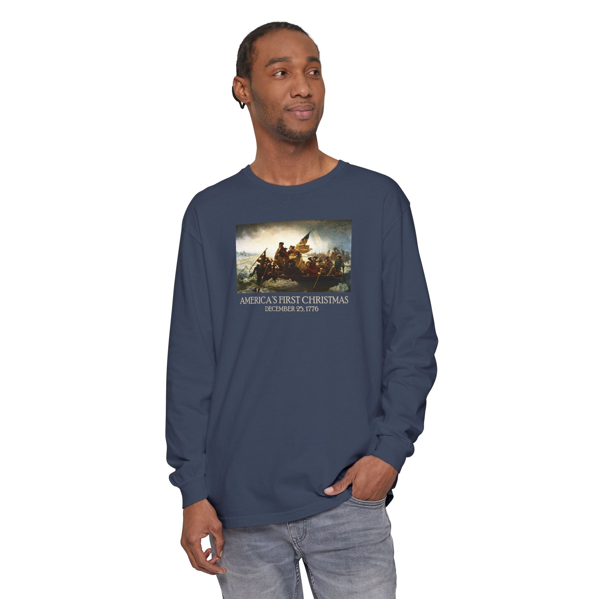 Man wearing a long-sleeve Midnight Comfort Colors t-shirt with Leutze's 'Washington Crossing the Delaware' with 'America's First Christmas December 25, 1776 printed below