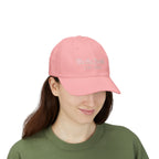 Woman wearing a pink cap with embroidered "We the People 1776-2026" 