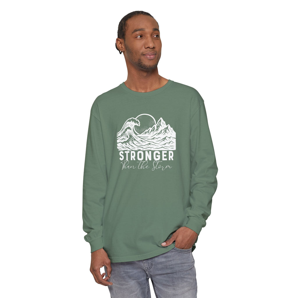 Male model in Stronger Than The Storm Christian long sleeve tee in light green