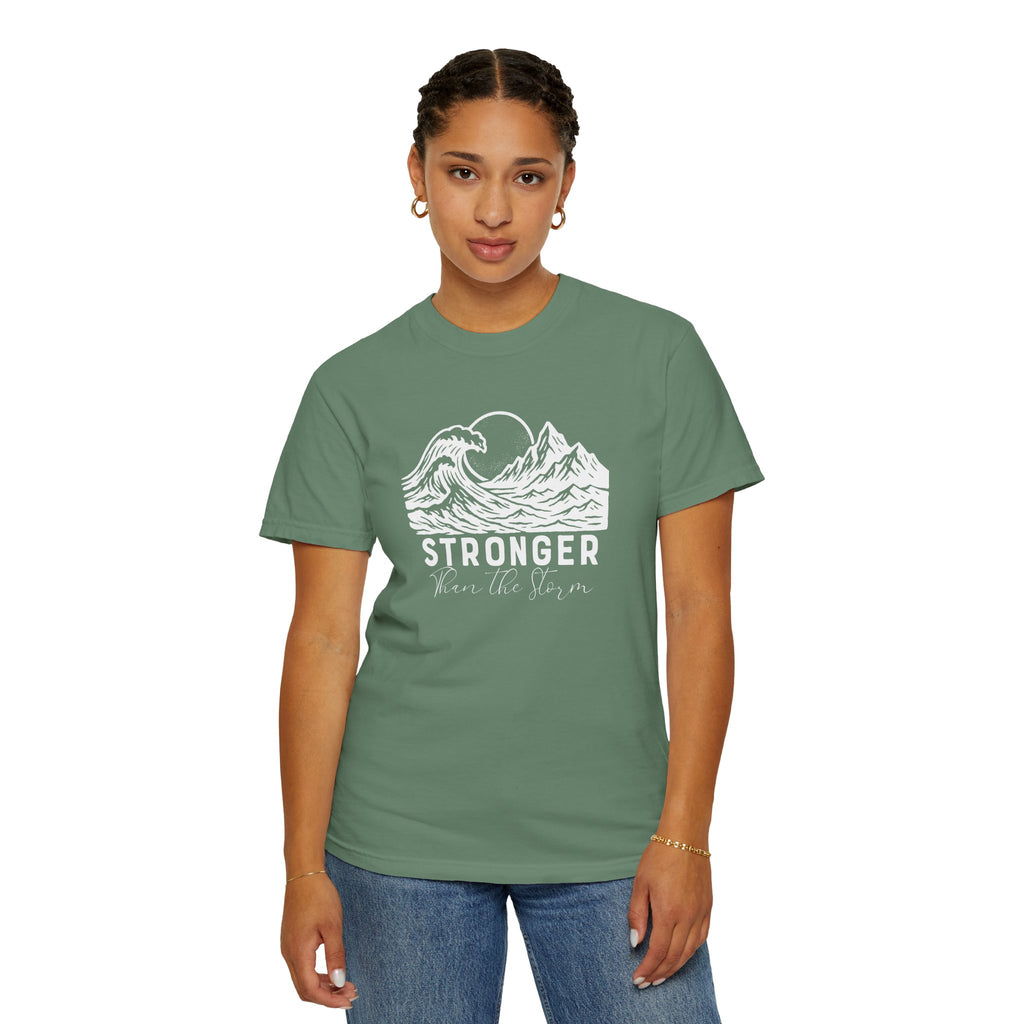 Person wearing Stronger Than The Storm faith t-shirt in light green