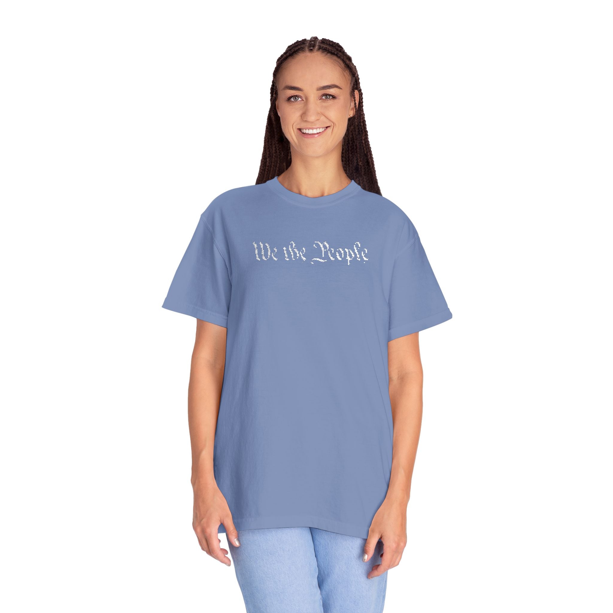 Smiling woman wearing oversized 'We the People' embroidered t-shirt in washed denim