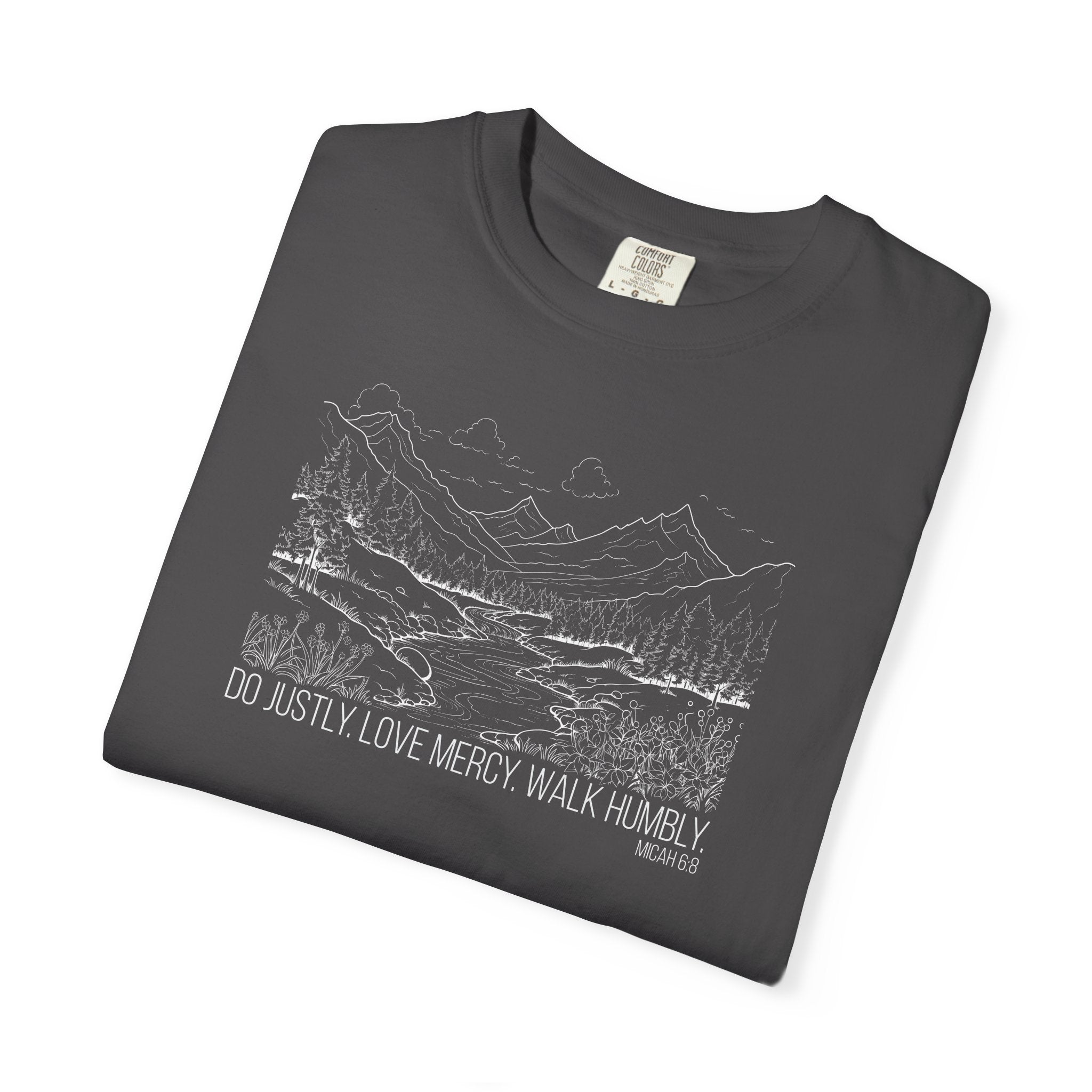 Folded Graphite Comfort Colors t-shirt with mountain river design and Bible verse from Micah 6:8