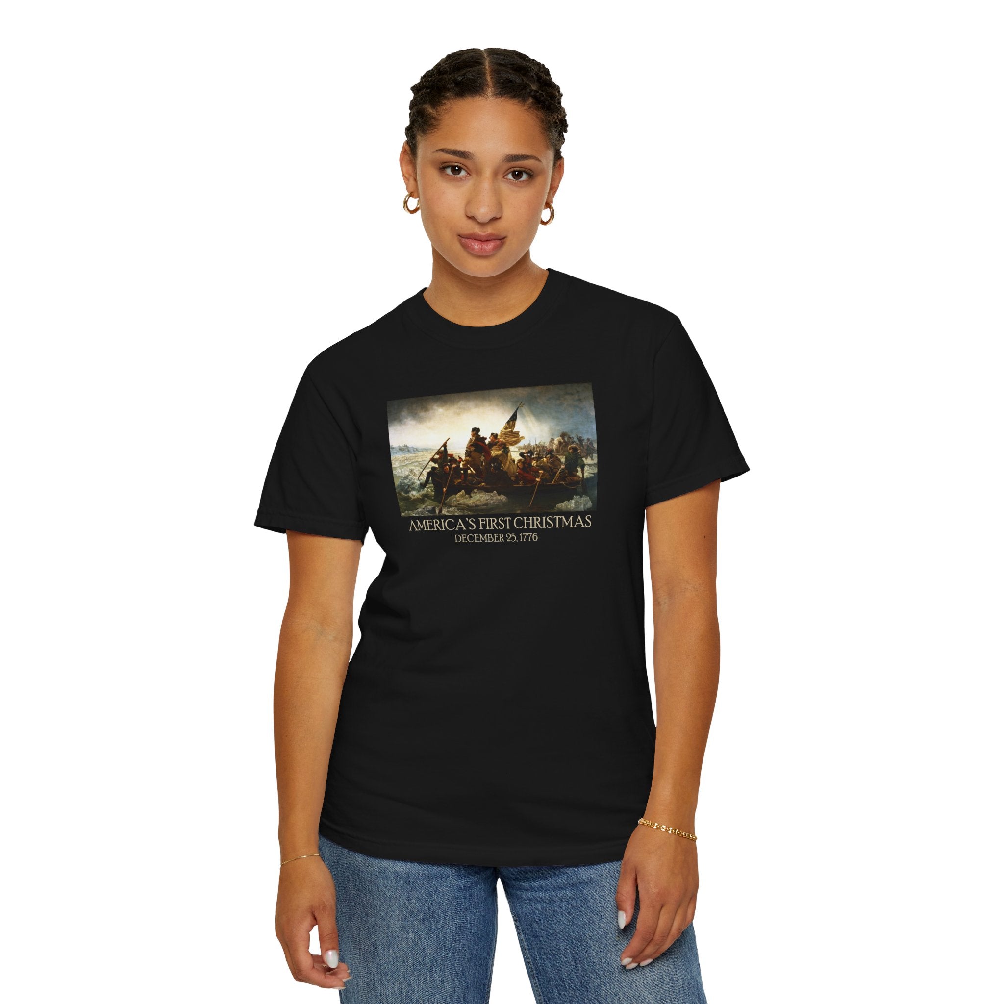 Woman wearing a Black Comfort Colors t-shirt with print of Emanuel Leutze’s 'Washington Crossing the Delaware' with 'America's First Christmas December 25, 1776' printed below 