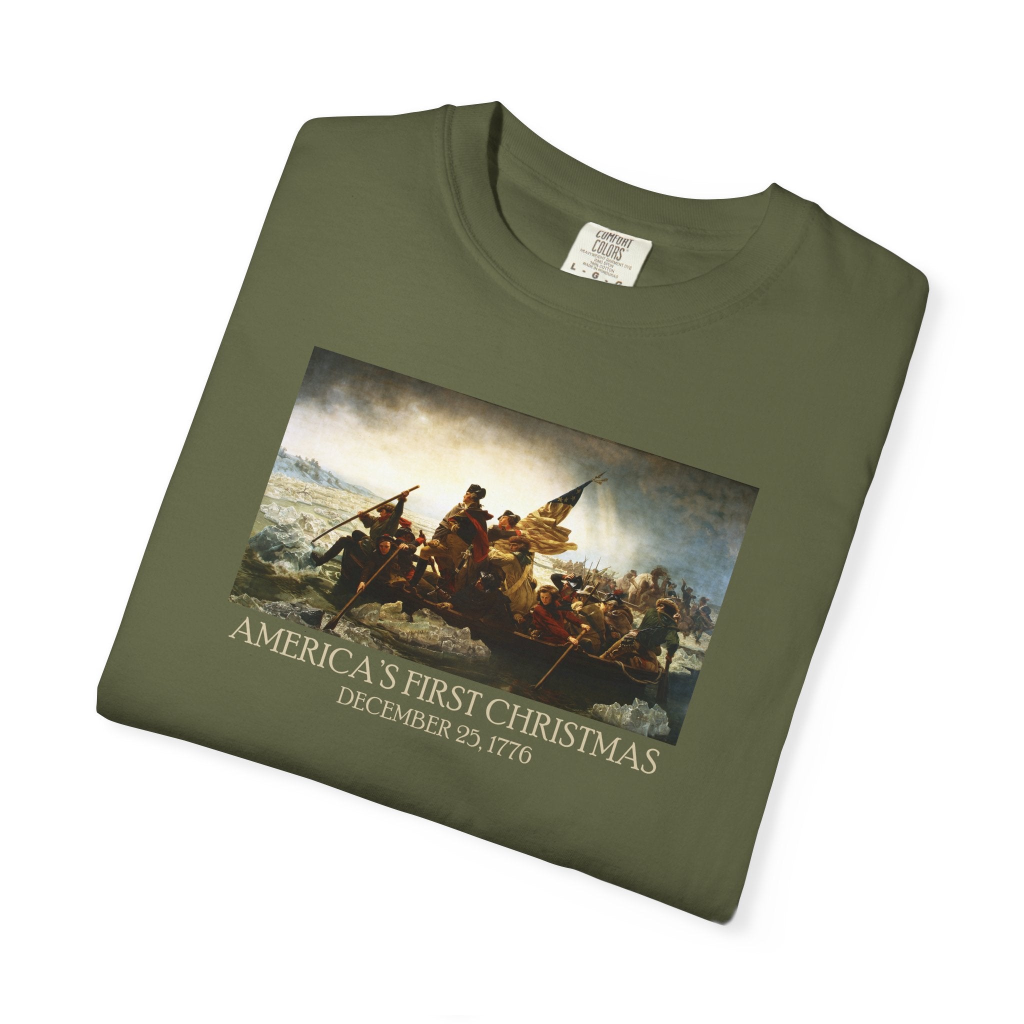 Folded Hemp Comfort Colors t-shirt with print of Emanuel Leutze’s 'Washington Crossing the Delaware' with 'America's First Christmas December 25, 1776' in period font below 