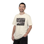 Man wearing an Ivory Comfort Colors t-shirt printed with a montage of four revolutionary war era paintings