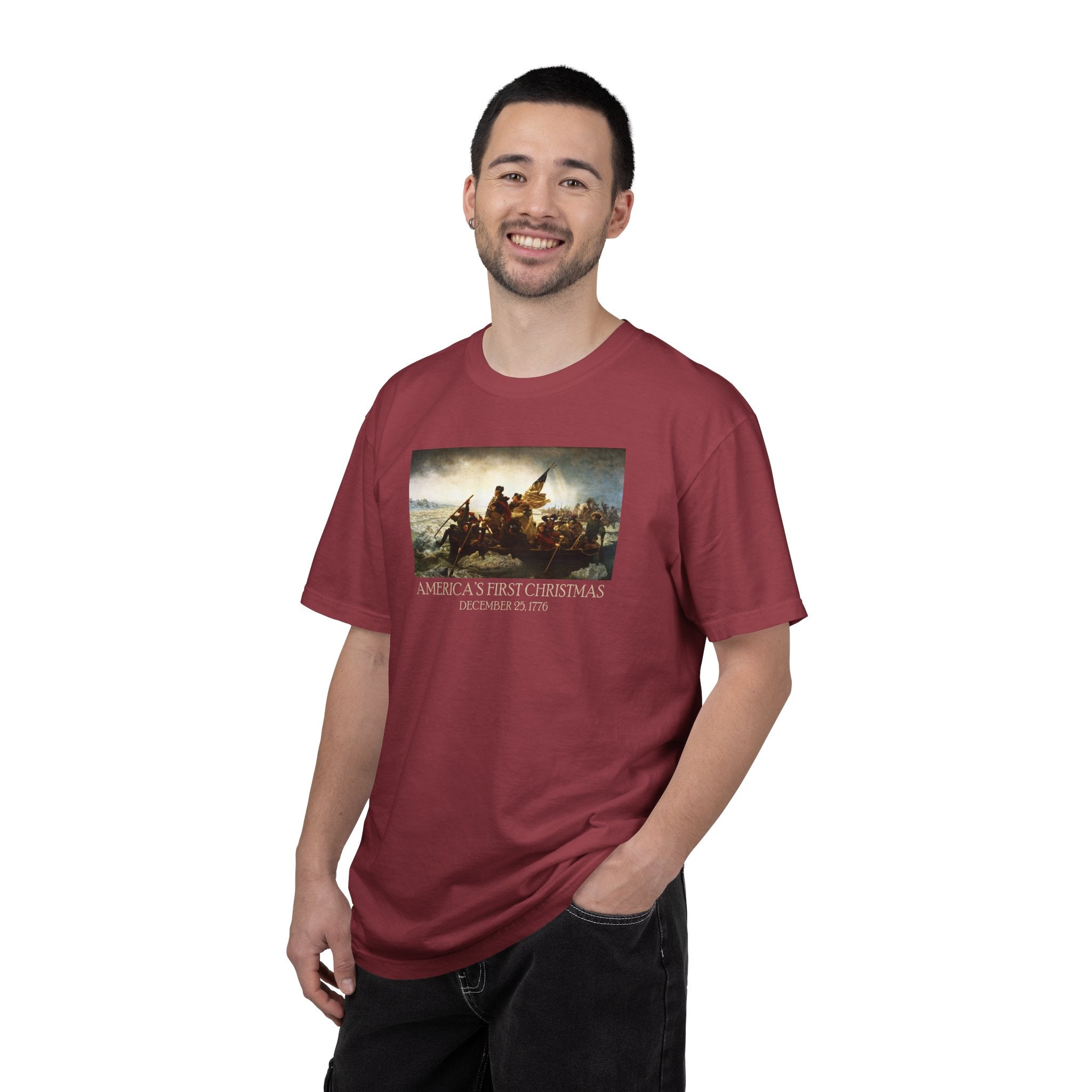 Smiling man wearing a Chili Comfort Colors t-shirt with print of Emanuel Leutze’s 'Washington Crossing the Delaware' with 'America's First Christmas December 25, 1776' printed below 