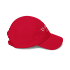 Side view of a cranberry red cap 