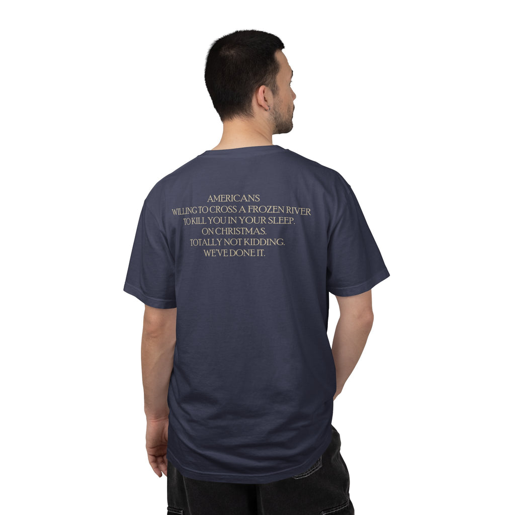 Back view of male model wearing America's First Christmas meme t-shirt with 'AMERICANS Willing to cross a frozen river to kill you in your sleep. On Christmas.' quote. Denim