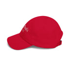 Side view of a cranberry red cap 