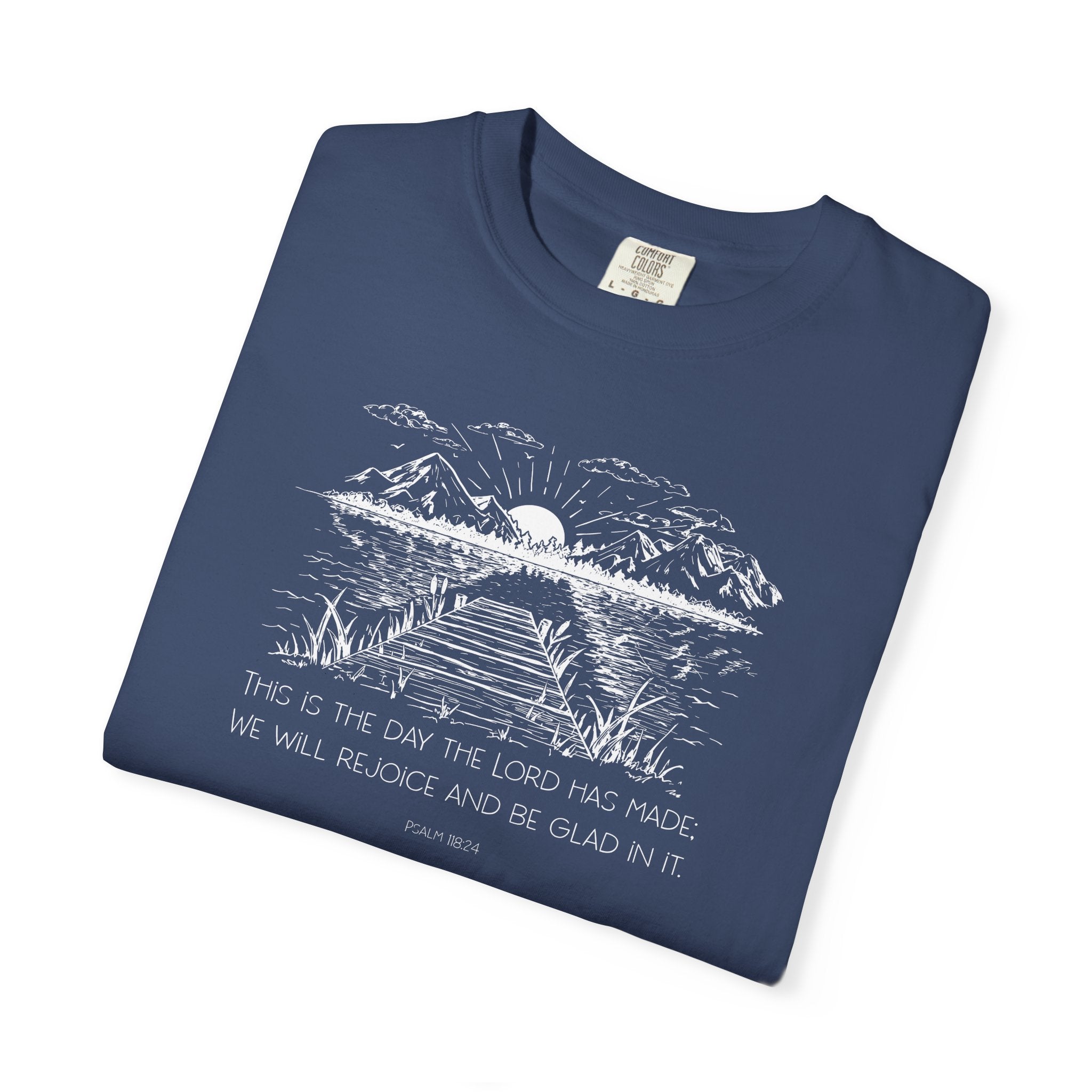 Folded China Blue Comfort Colors t-shirt with nature graphic and Psalm 118:24 beneath it