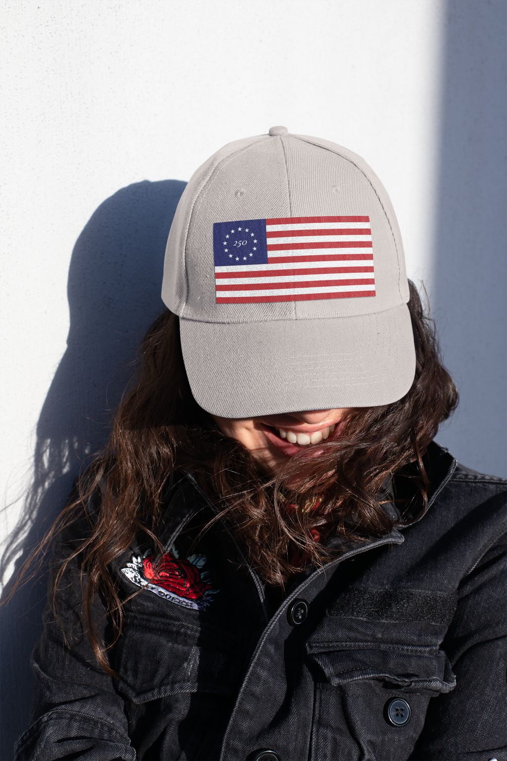 Model wearing a stone cap embroidered with Betsy Ross flag