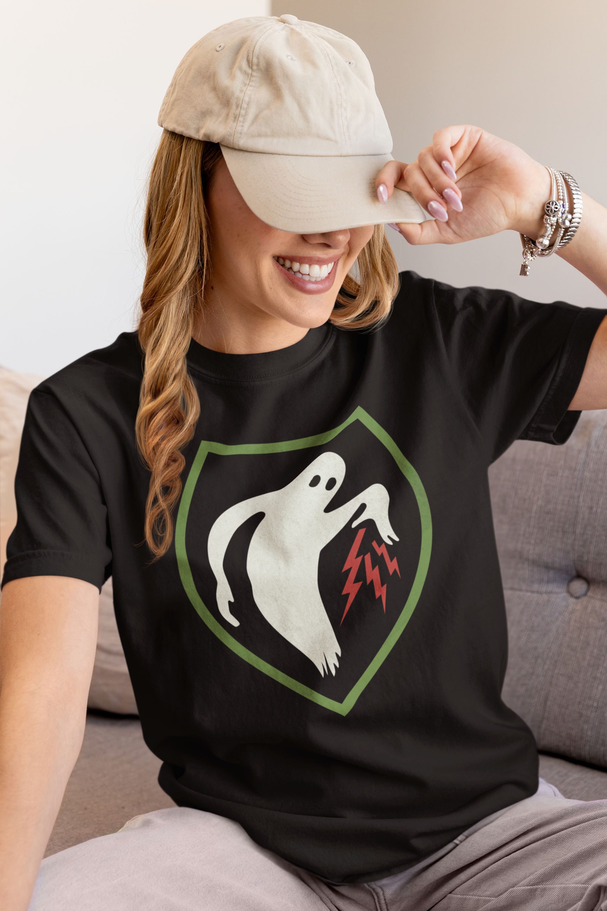 Model wearing a Ghost Army patriotic t-shirt in black sitting on a couch