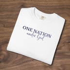 folded 'One Nation Under God' embroidered patriotic t-shirt with blue thread laying on a wooden surface