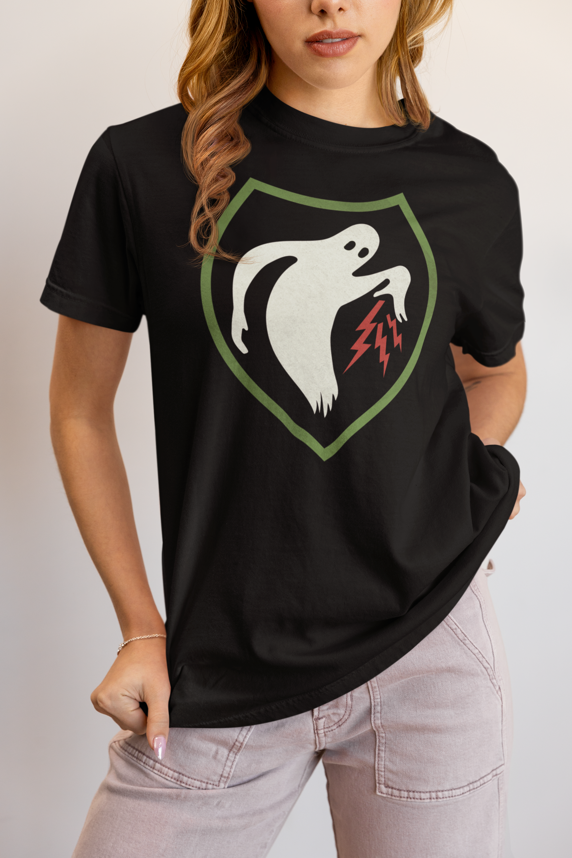 Woman wearing a black t-shirt with the Ghost Army logo